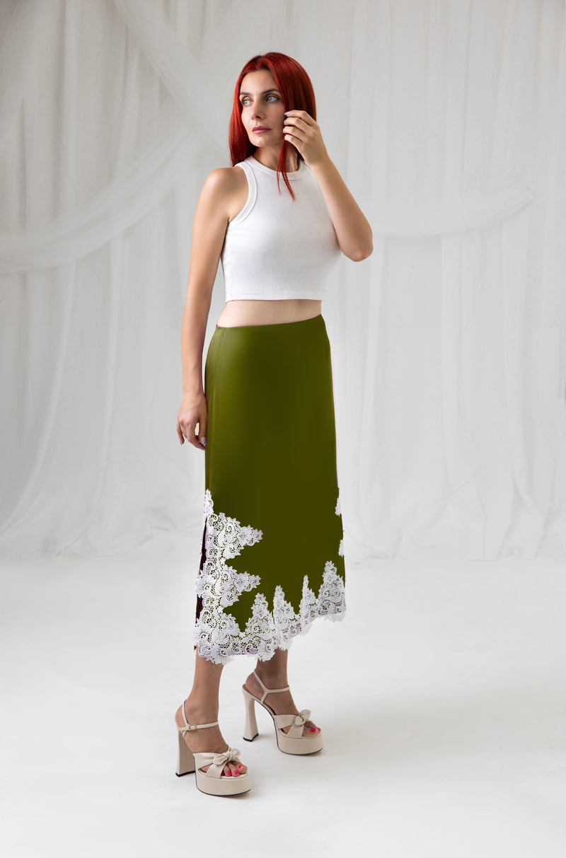 Model wearing the green satin midi skirt with ivory lace hem, side view