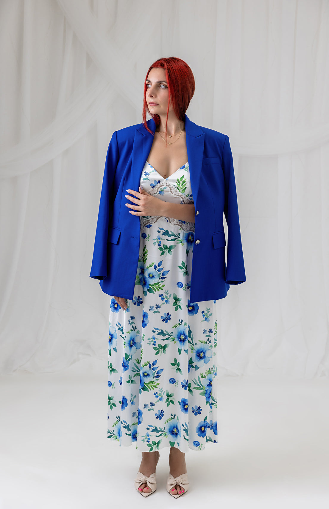 Model wearing the House of Lluvie' cobalt blue blazer with the Azure Bloom floral maxi dress, front view