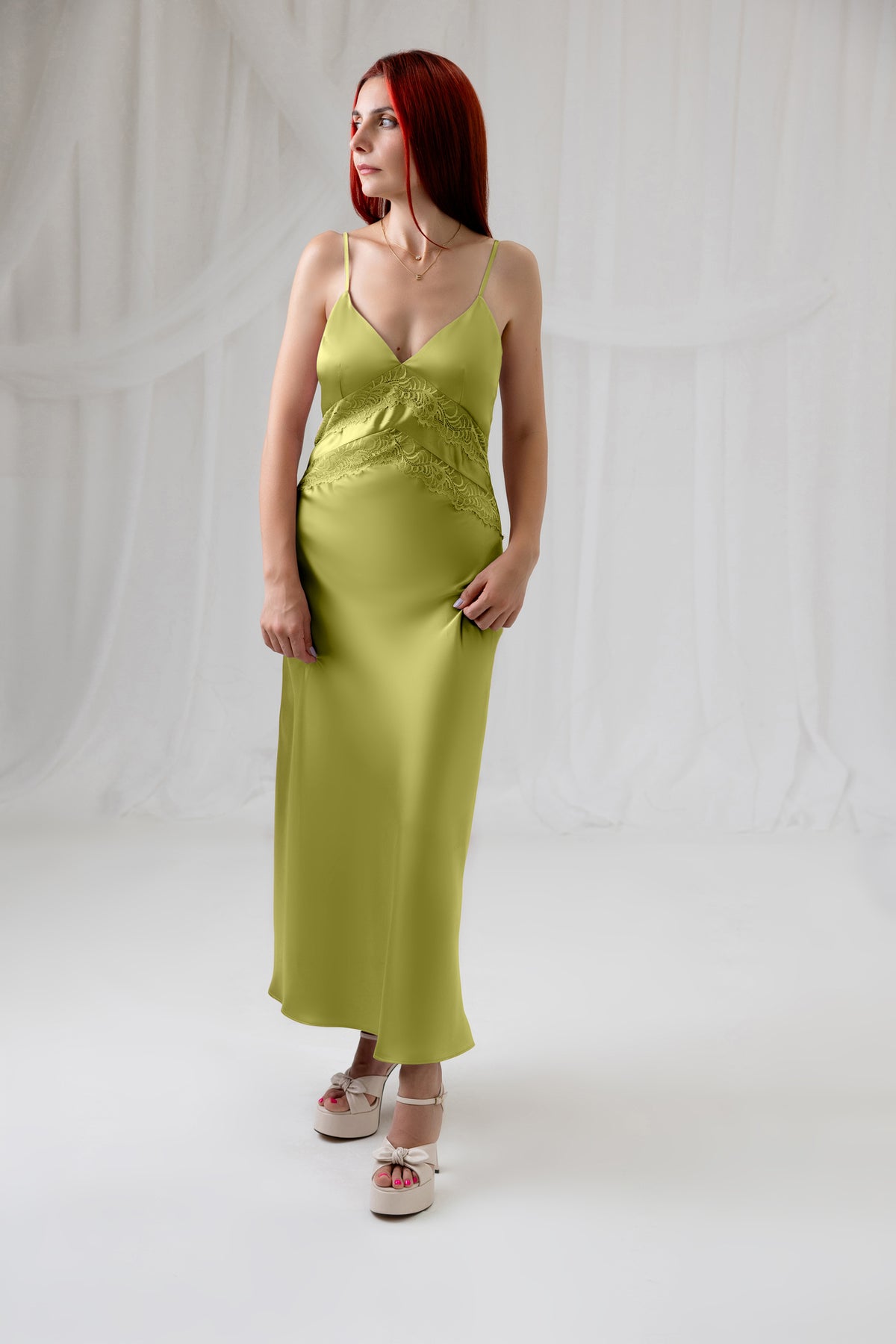 Model wearing the House of Lluvie' green satin slip dress, full-length front view