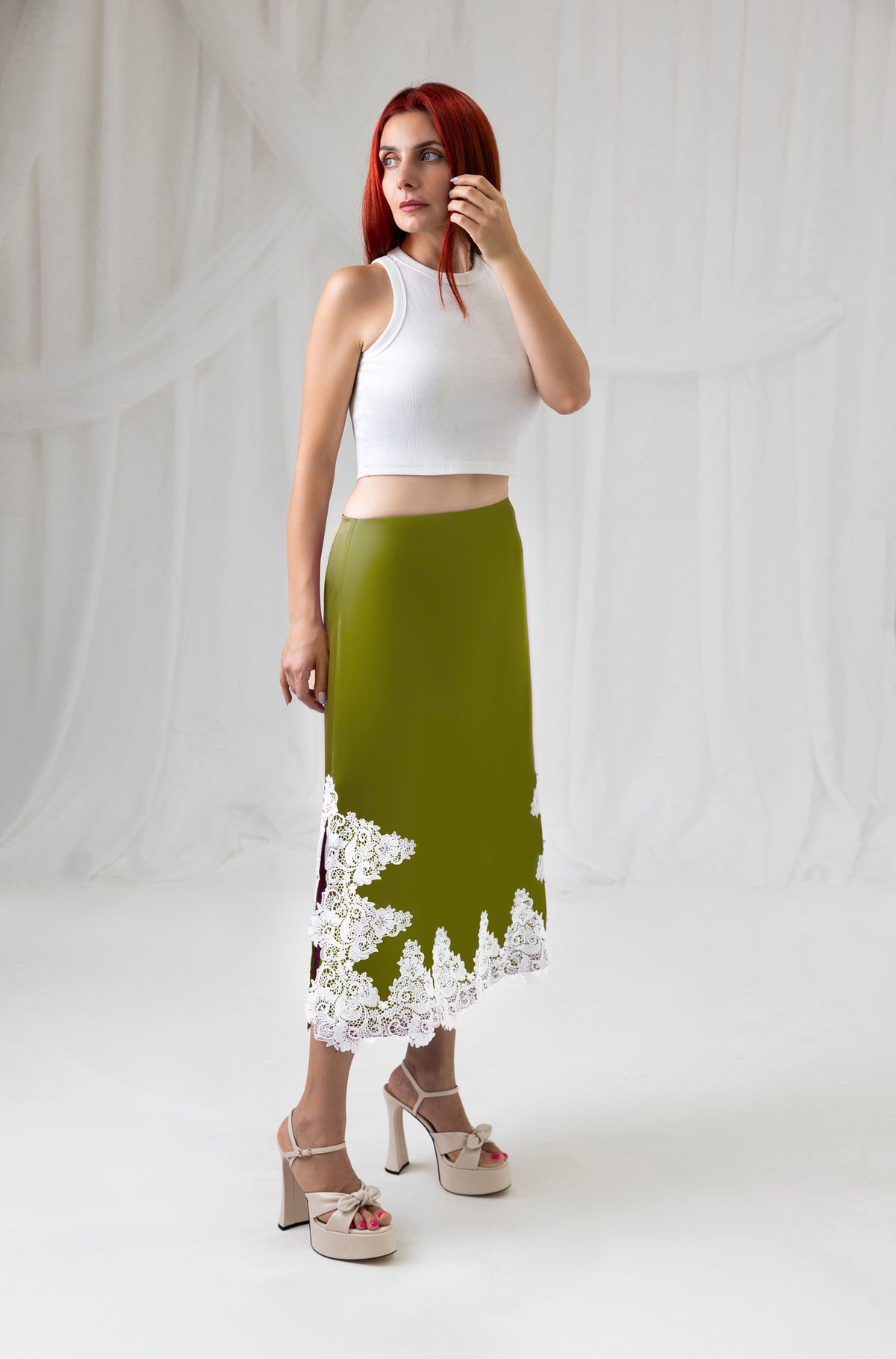 House of Lluvie' green satin midi skirt with ivory lace trim, full-length front view