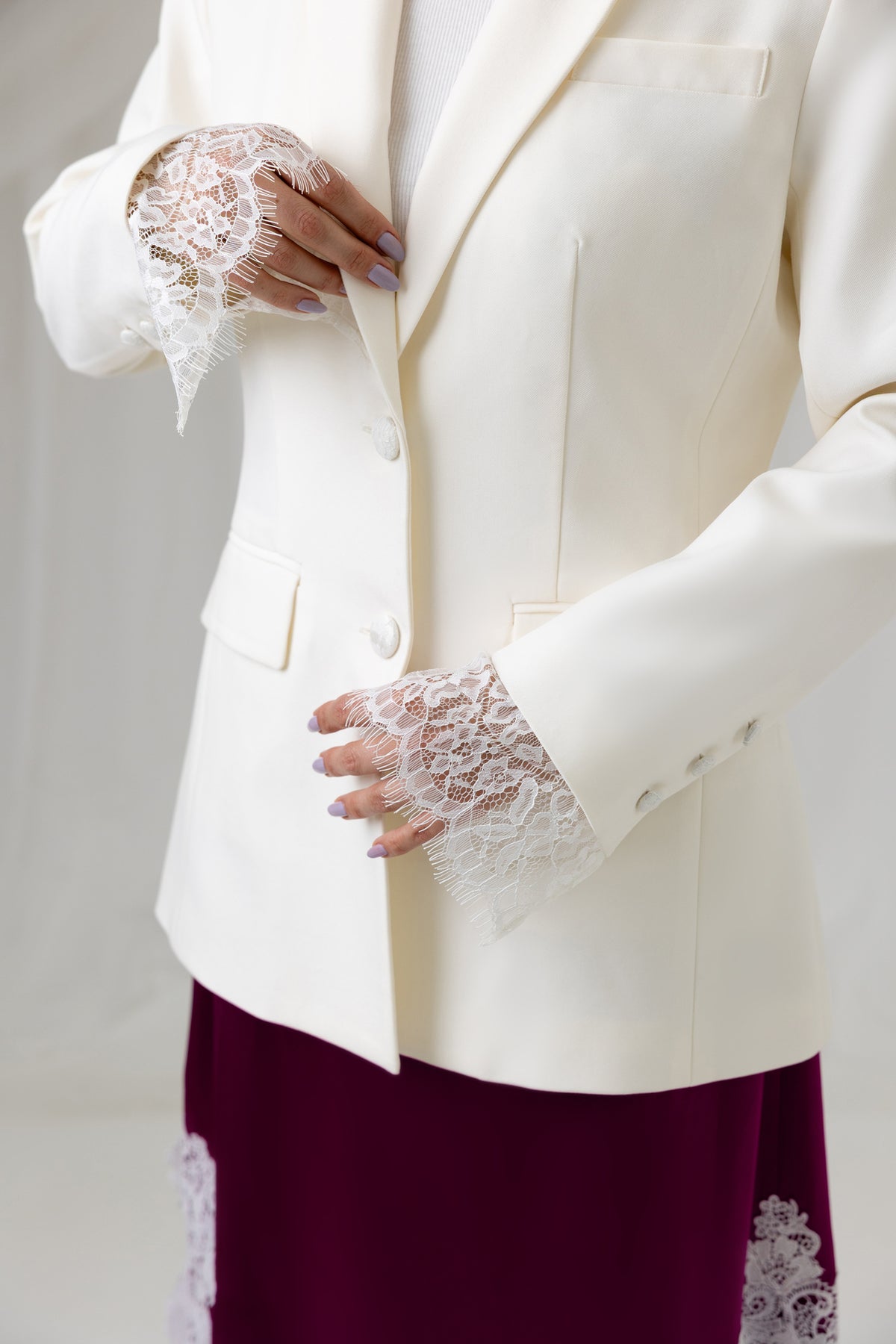 Close-up of the Ivory Muse Blazer front buttons and tailored construction