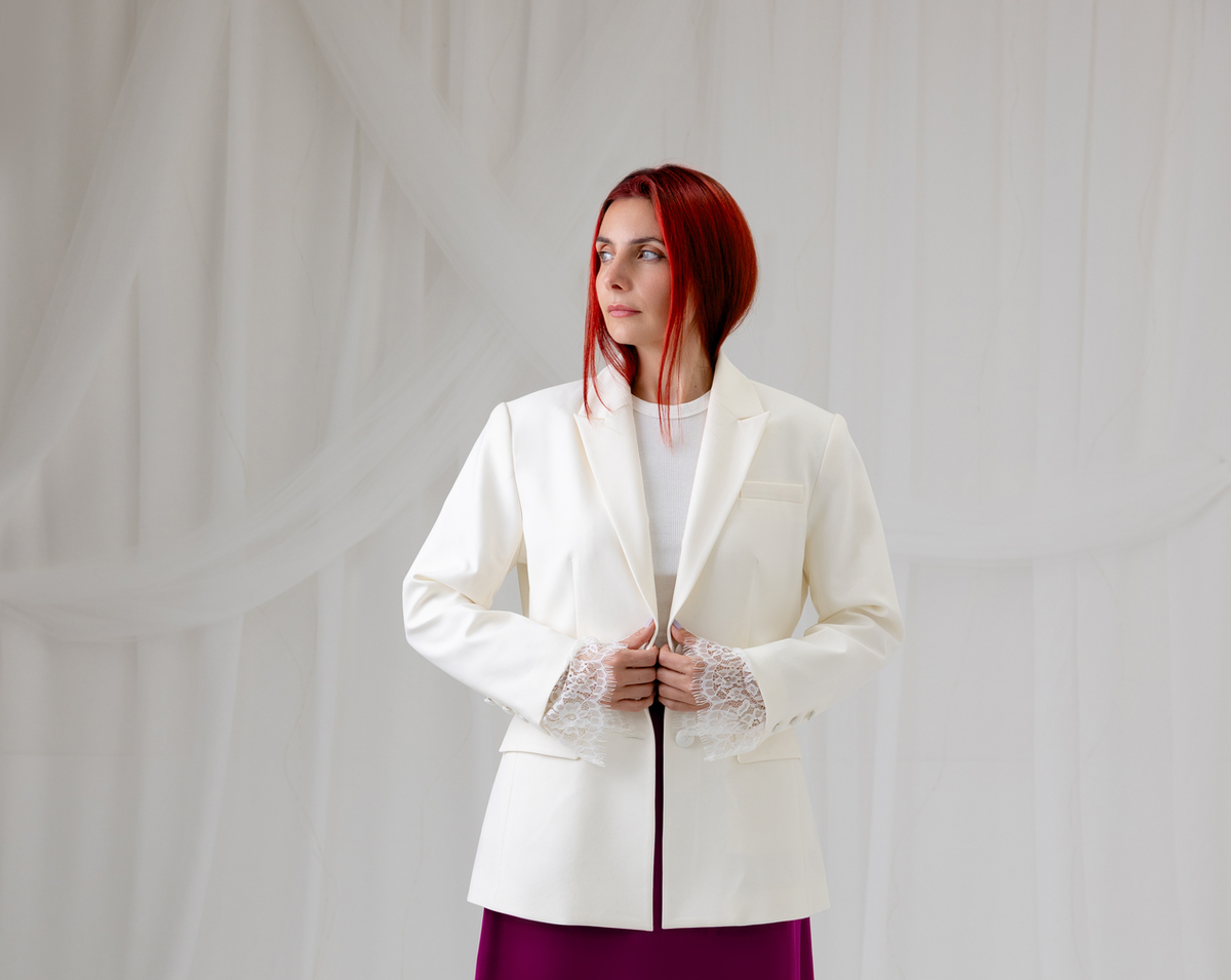 Model wearing the House of Lluvie' Ivory Muse Blazer with a burgundy lace midi skirt, full-length front view.