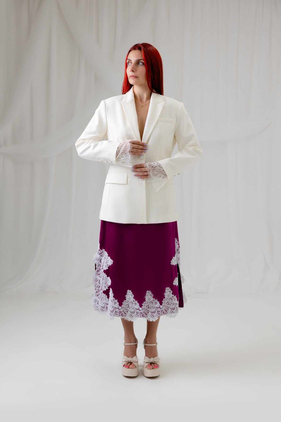 Model wearing the House of Lluvie' Ivory Muse Blazer with a burgundy lace midi skirt, full-length front view