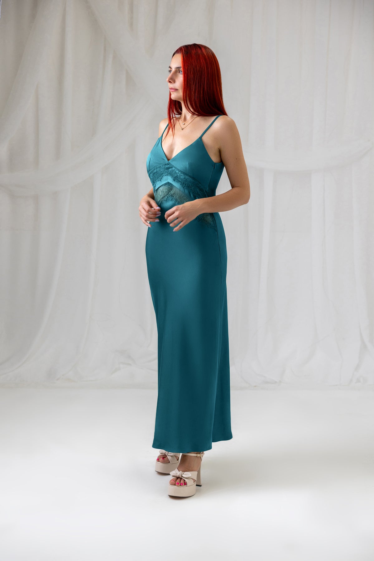 Teal satin slip dress with delicate lace detailing, three-quarter back view